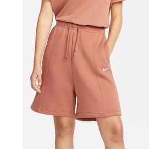 Medium sized woman’s high waisted peachy orange Nike shorts